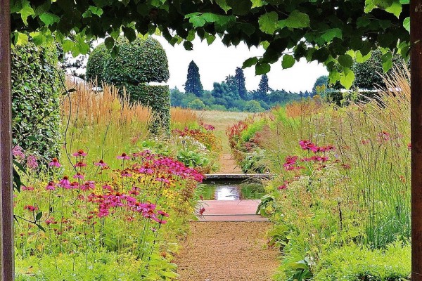 Walled garden with prairie plantings and water rill at Broughton Grange Garden